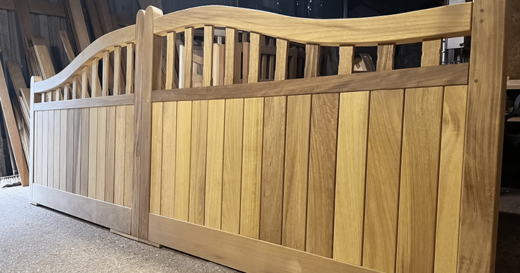Wooden driveway gate with arched top.