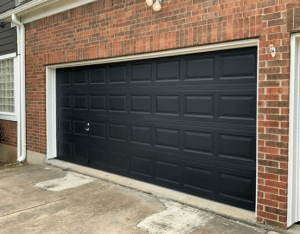 Black Garage Doors on a Red Brick House